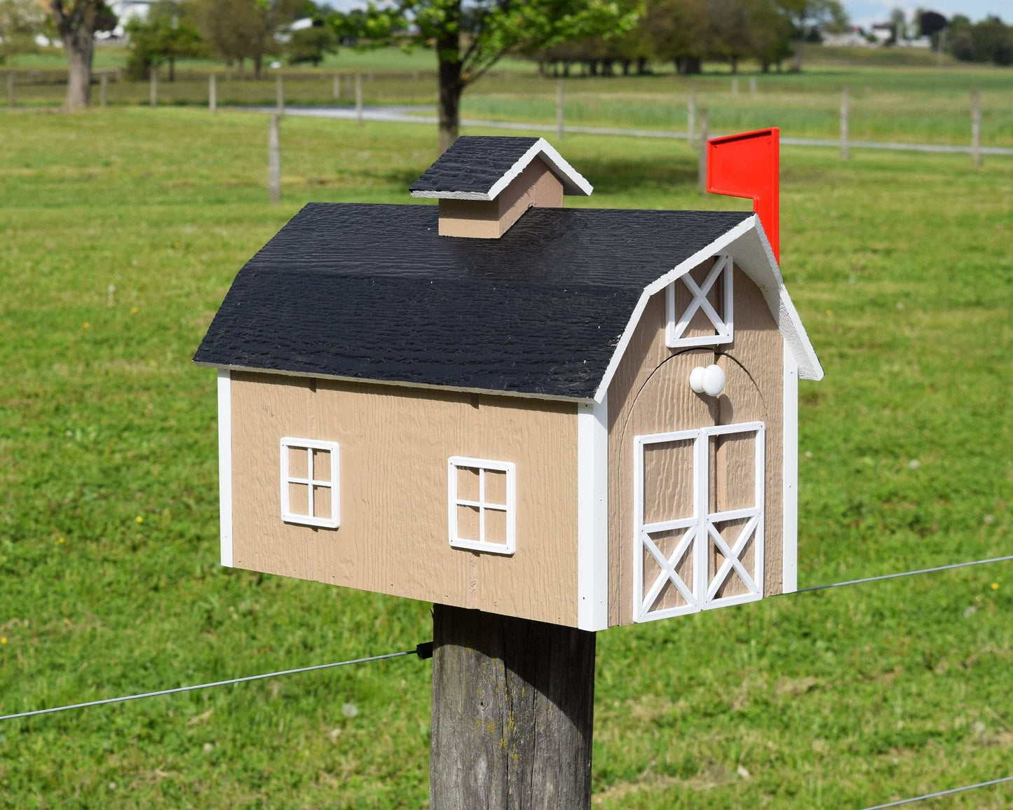 beige barn mailbox with red flag