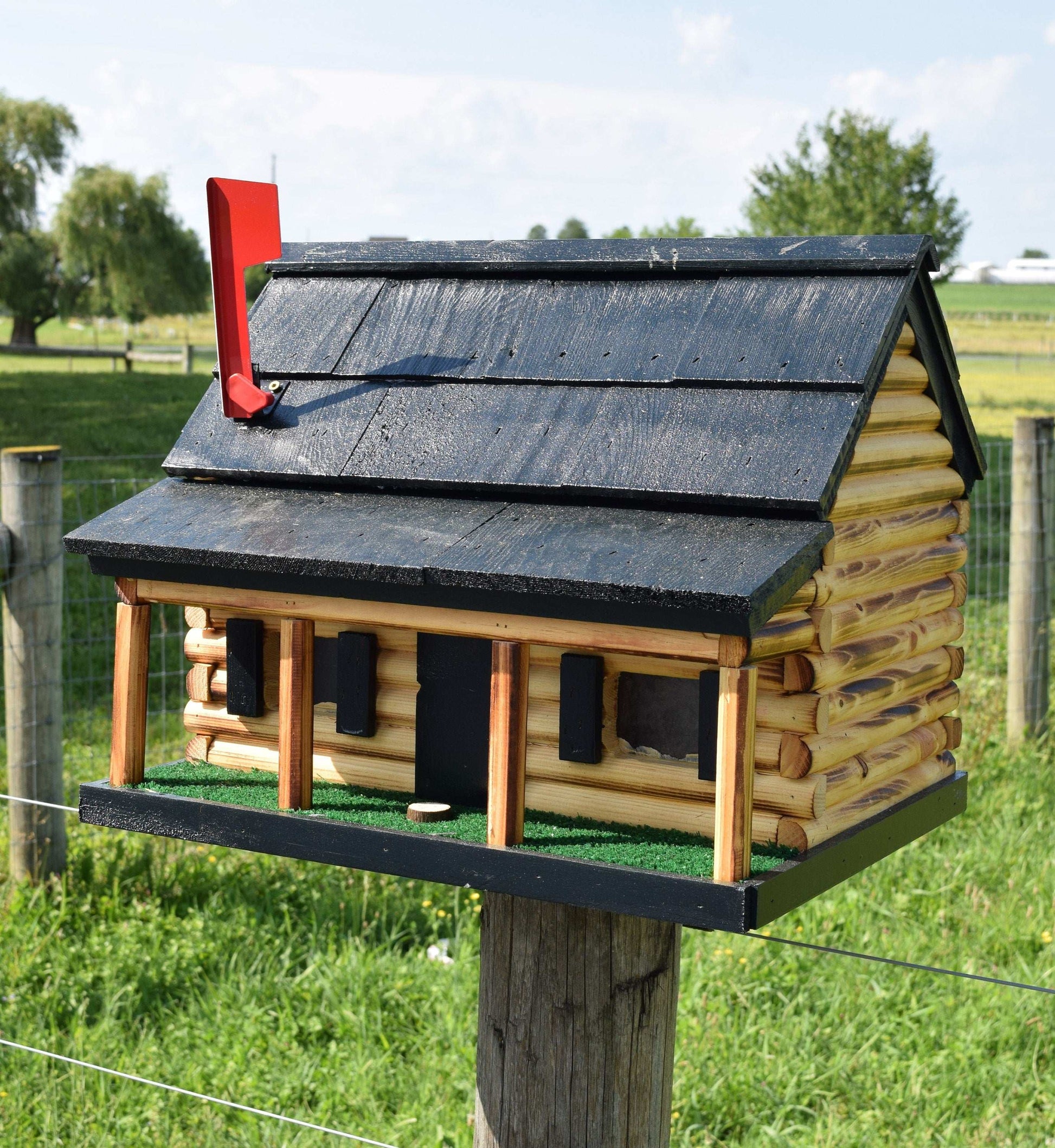 black log cabin with porch mailbox