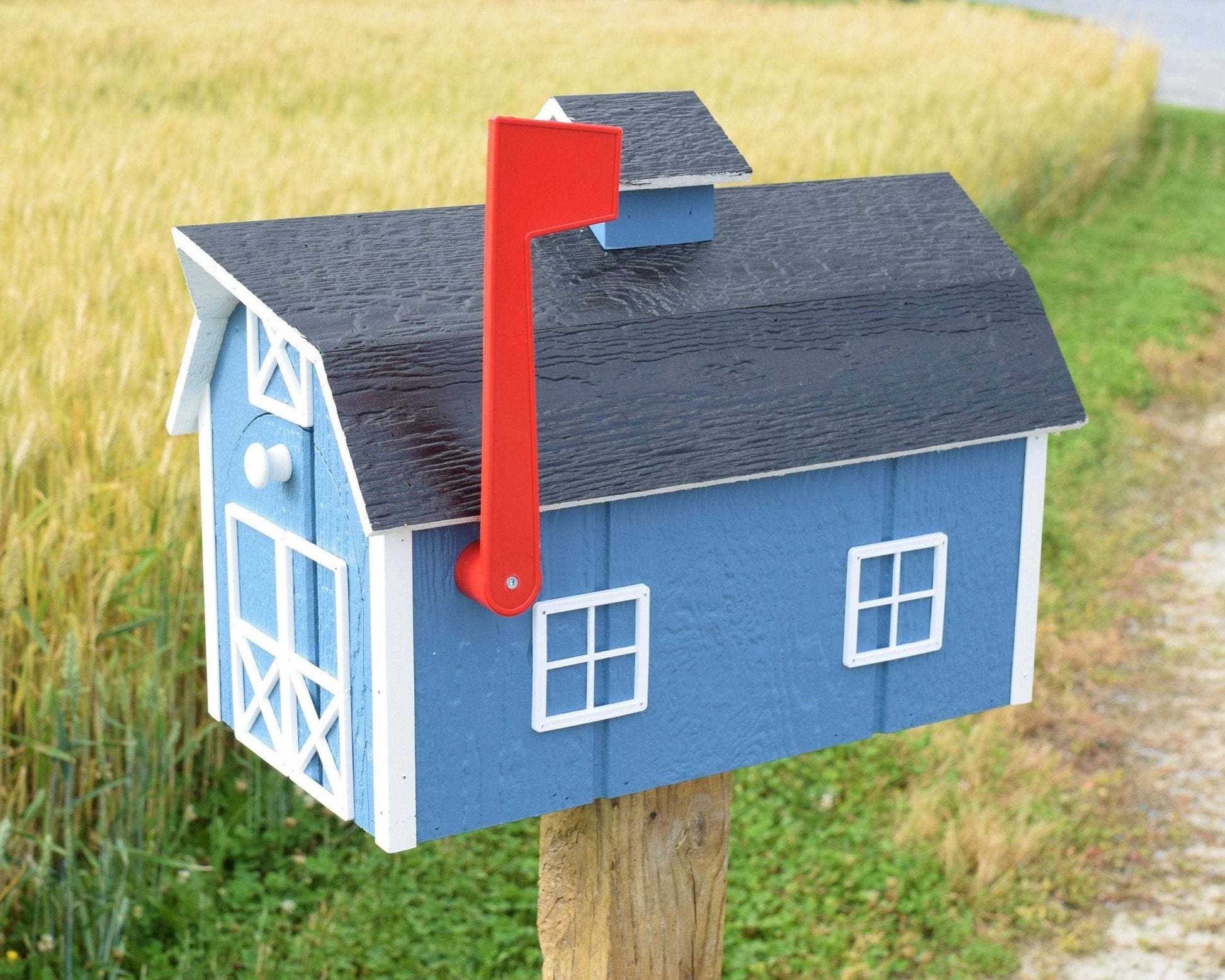 blue barn mailbox with red flag