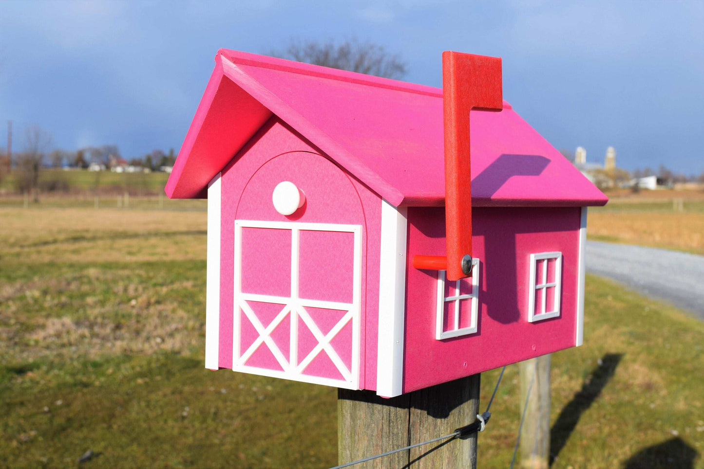 bright pink mailbox with white trim