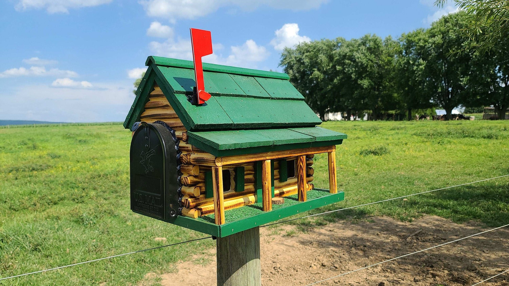 green log cabin with porch mailbox