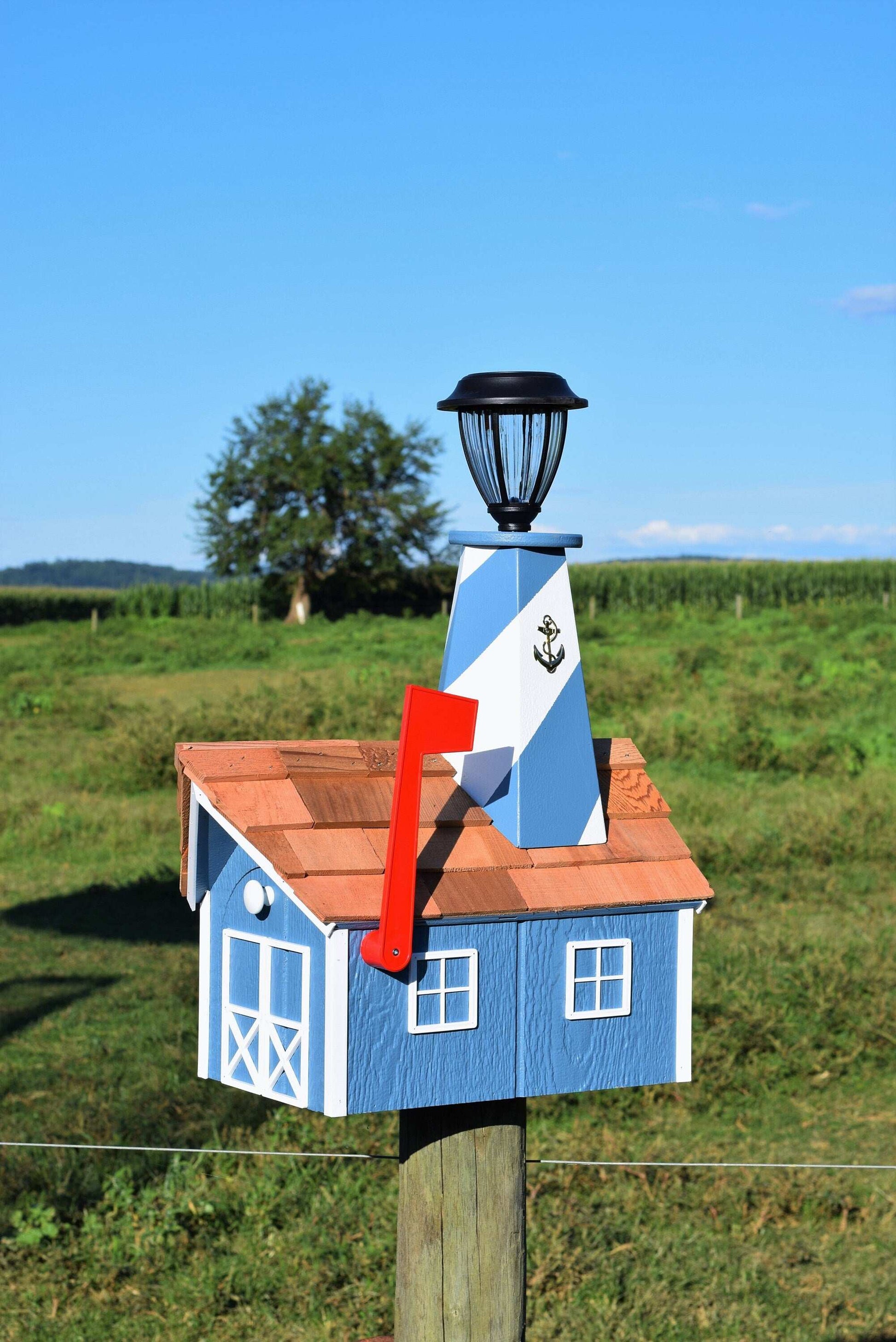 light blue and white lighthouse mailbox