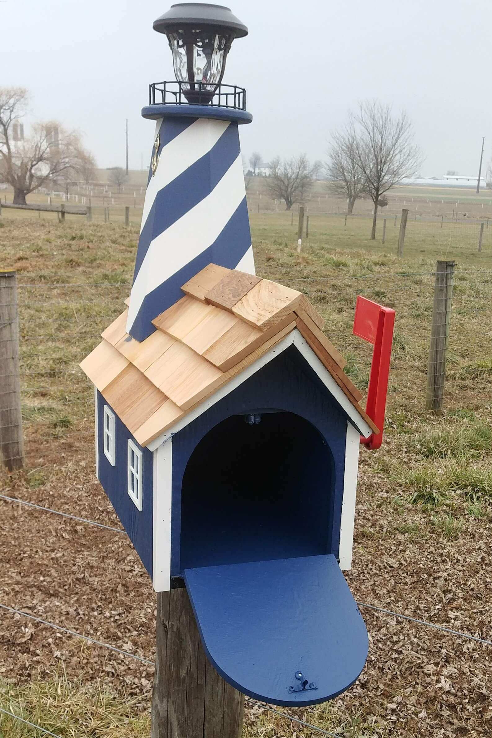 blue and white hatteras lighthouse mailbox open door
