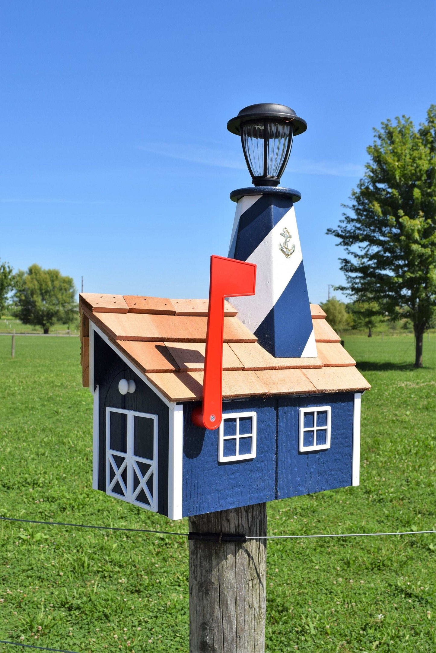 navy blue and white lighthouse mailbox