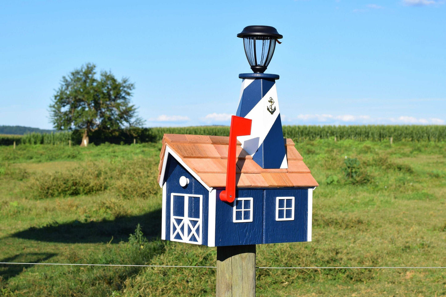 navy blue and white lighthouse mailbox