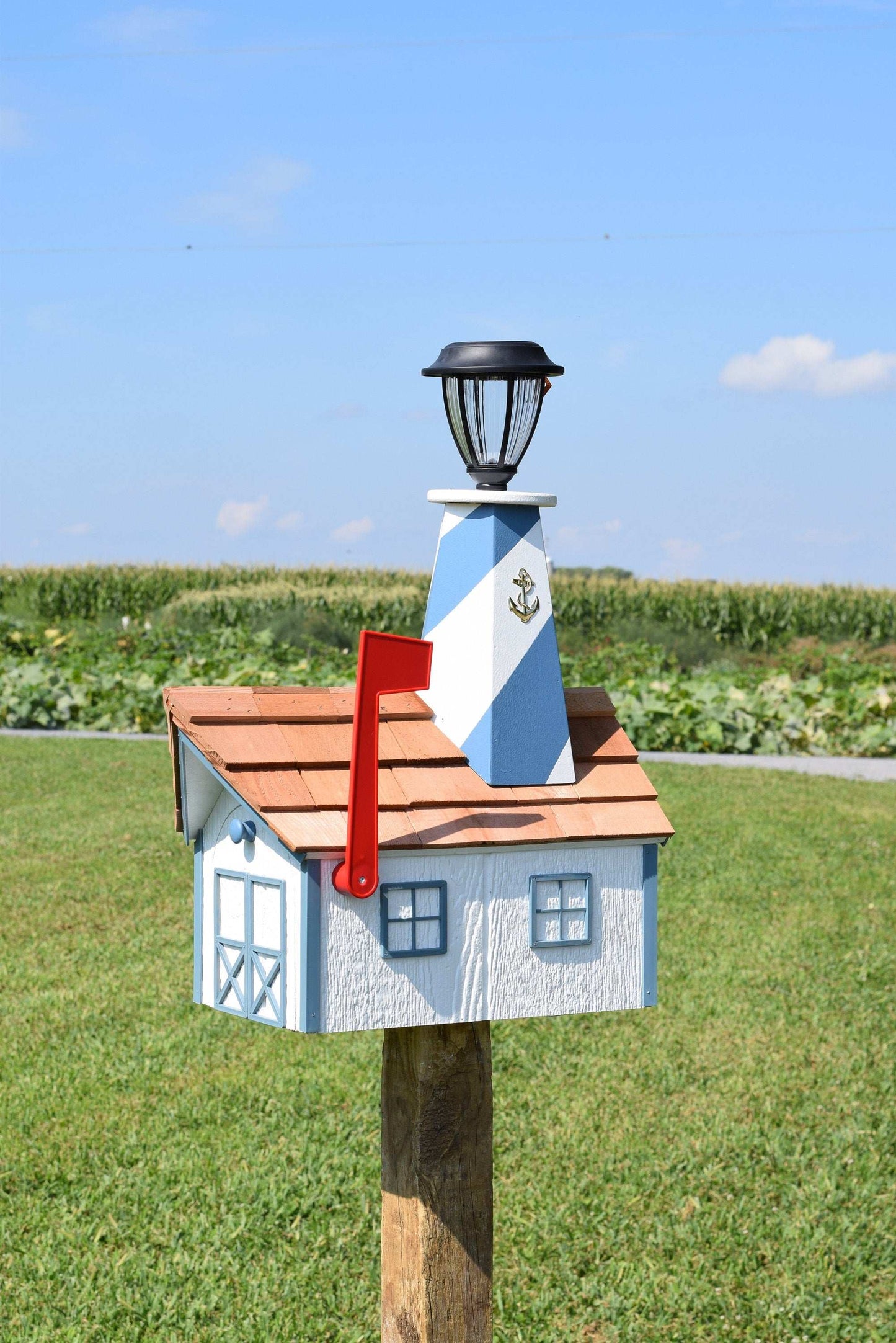 white and light blue lighthouse mailbox