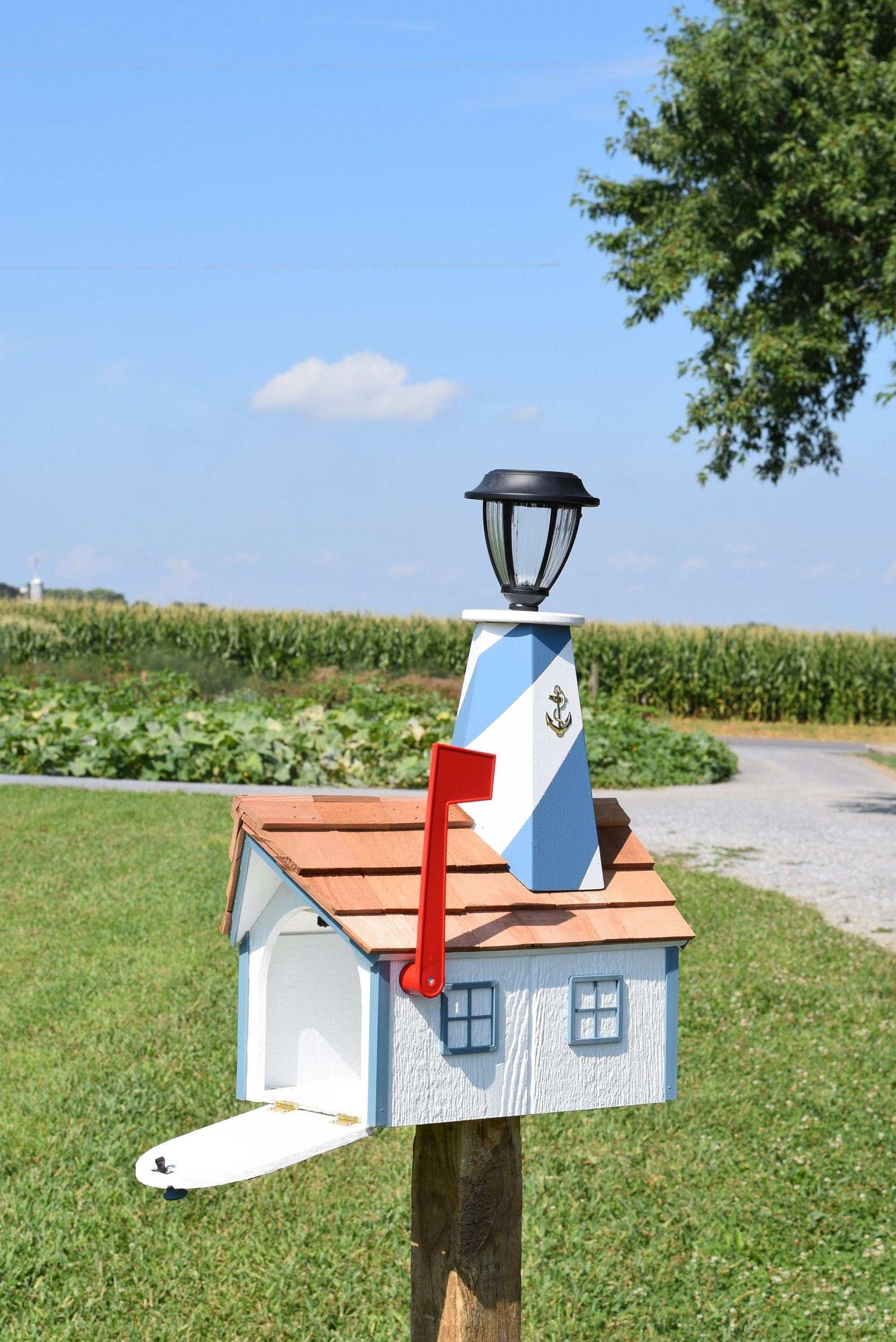 white and light blue lighthouse mailbox