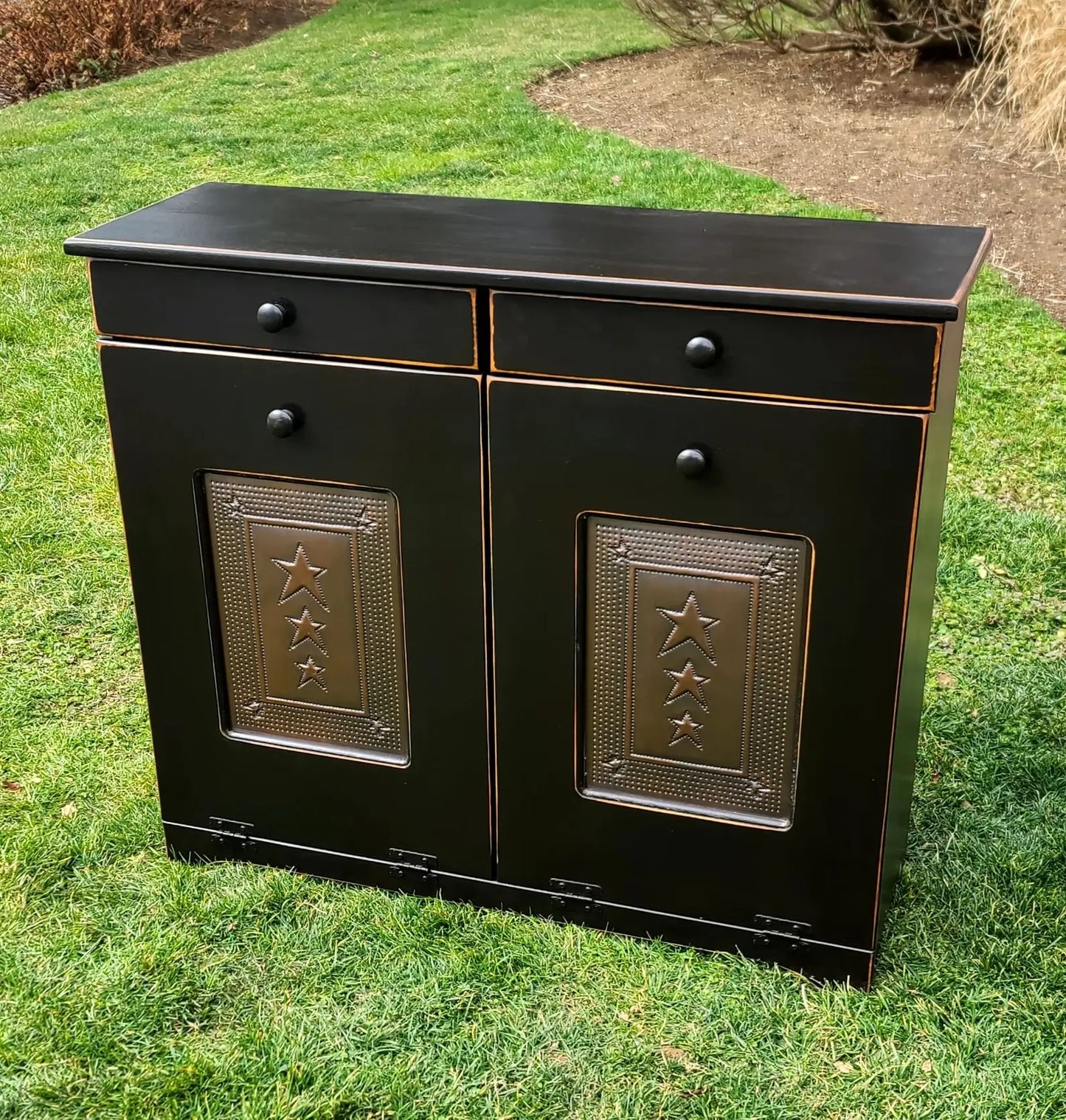 Black double trash bin with copper doors