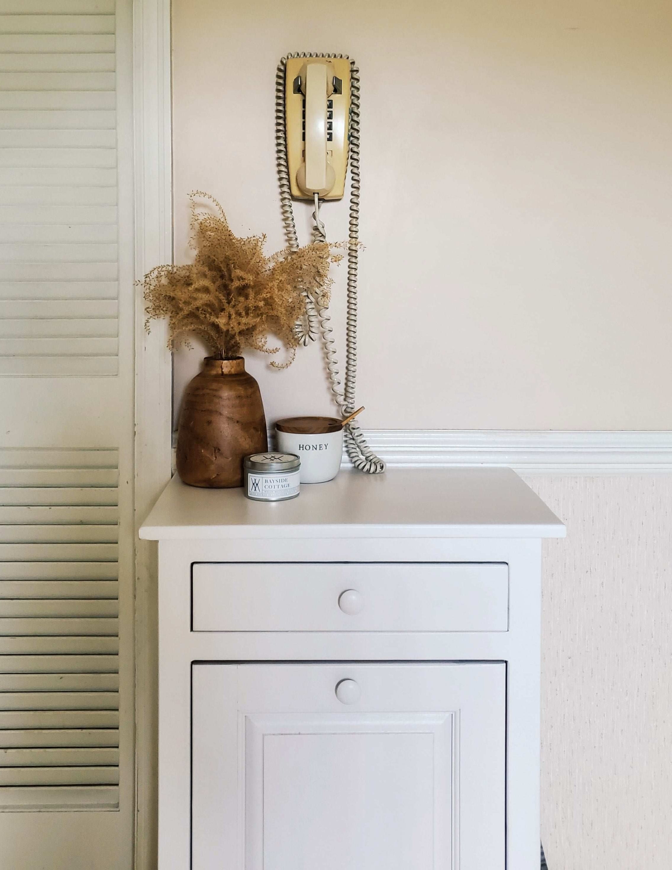 staged solid white primitive trash bin