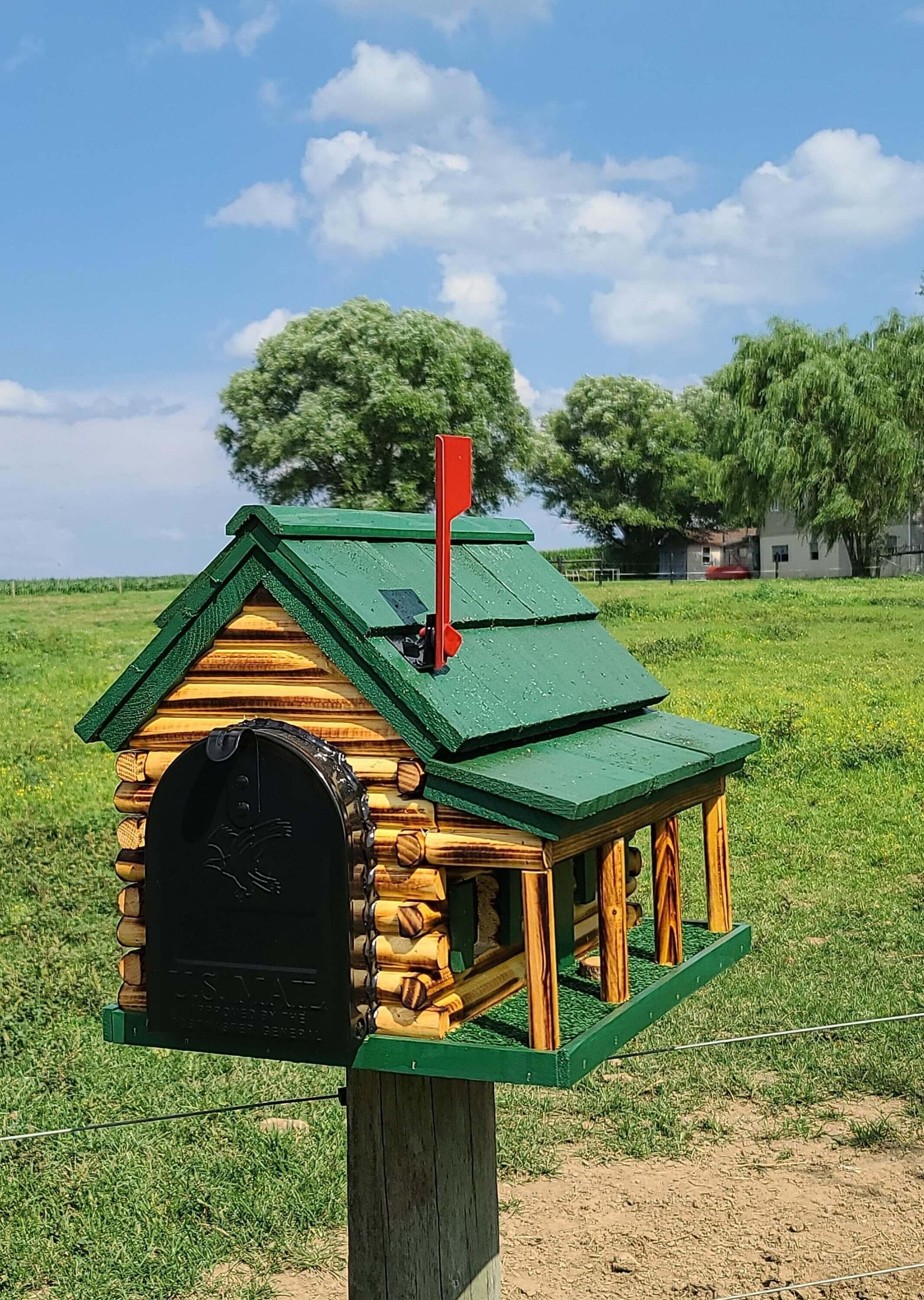 green log cabin with porch