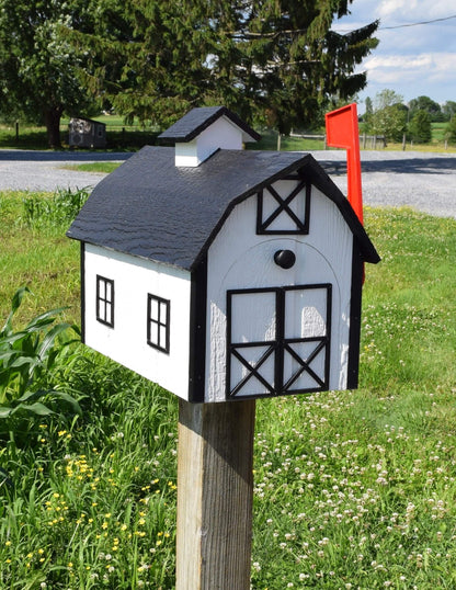 white and black barn mailbox with red flag