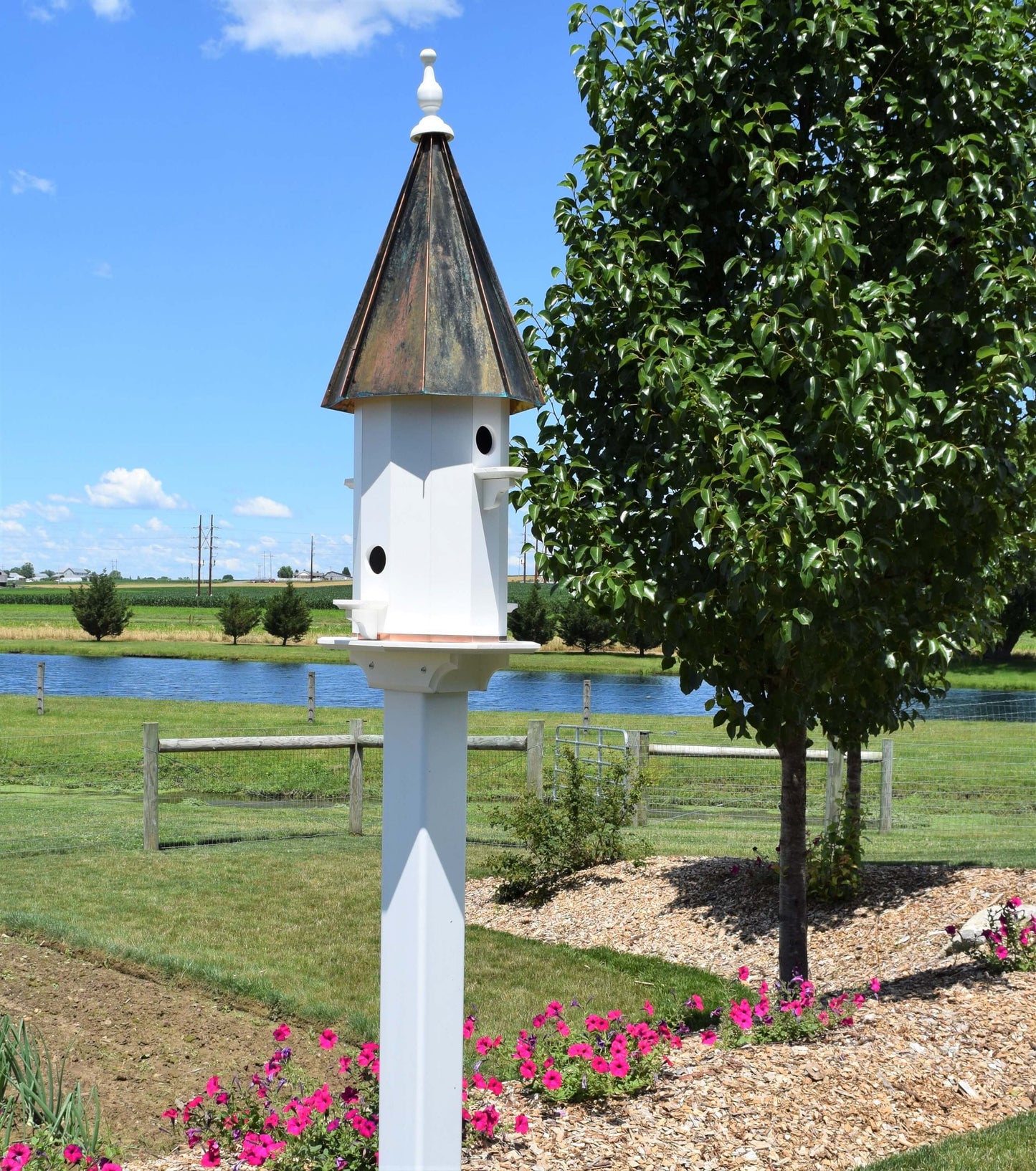 tall patina roof birdhouse by a pond