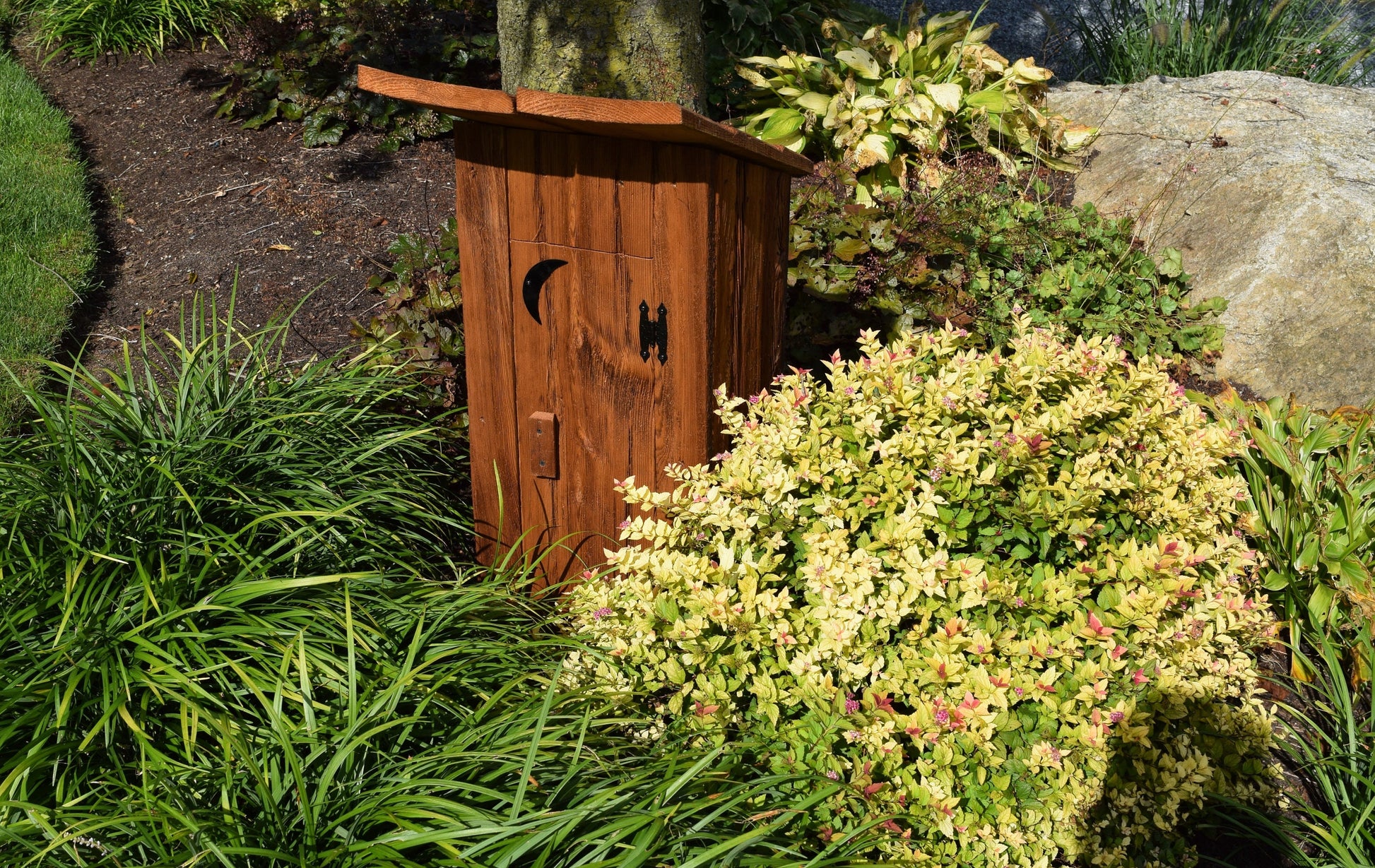 wooden outhouse well cover in garden