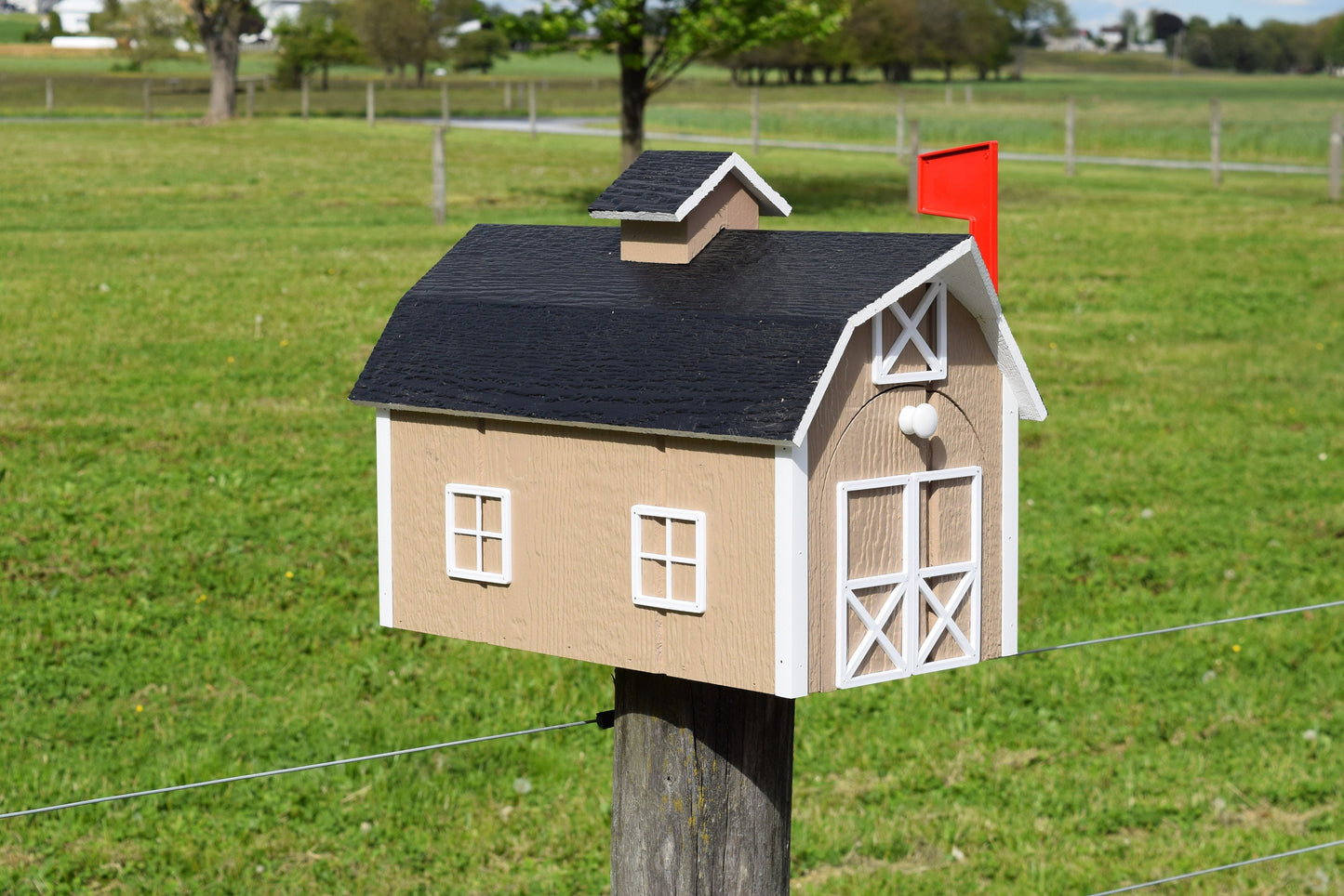 beige barn mailbox with red flag